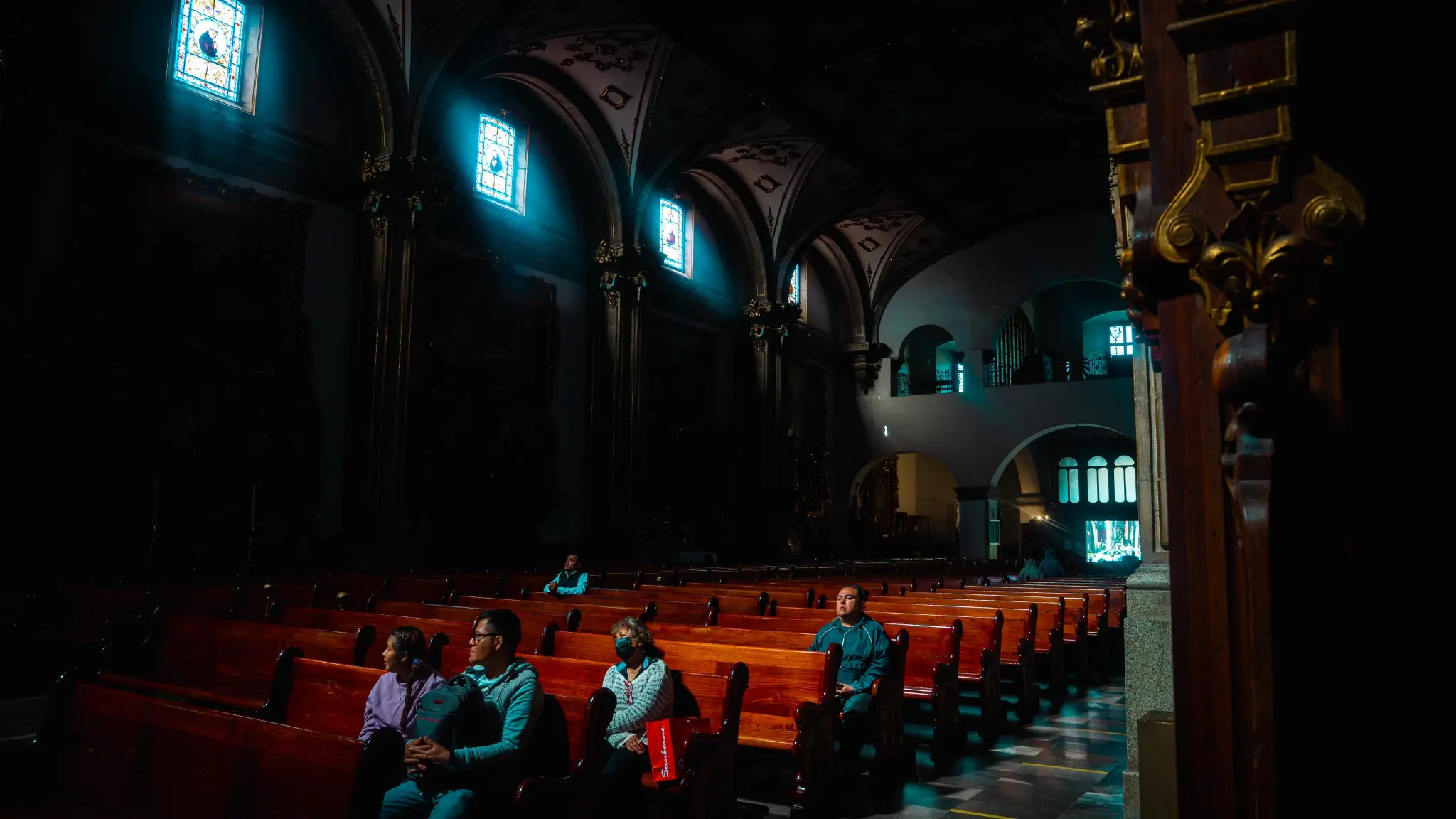Light streaming through stained glass inside a church